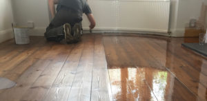 wooden floor polishing in progress