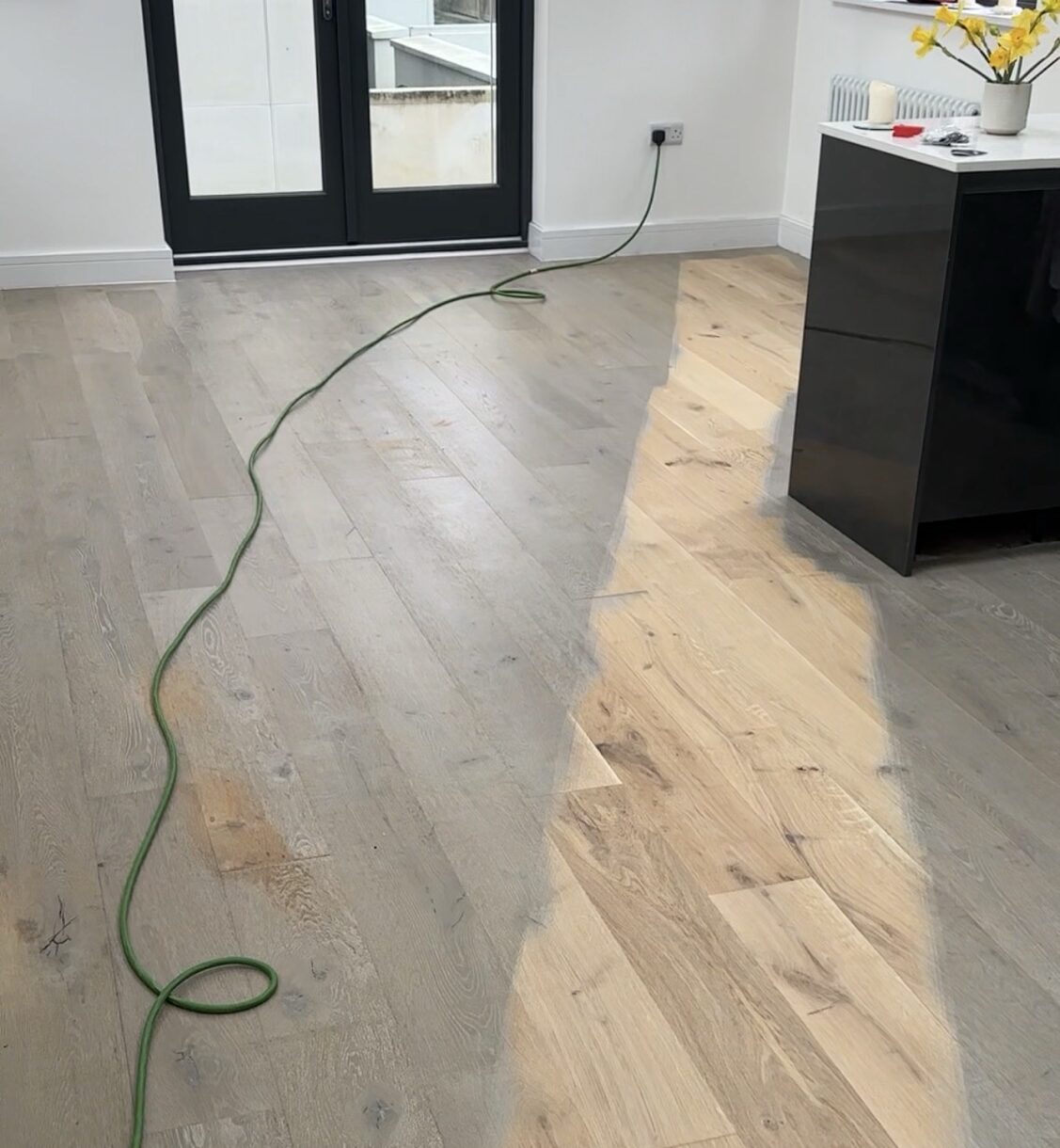 Sanding off that top layer of grey revealing the Engineered Oak beneath